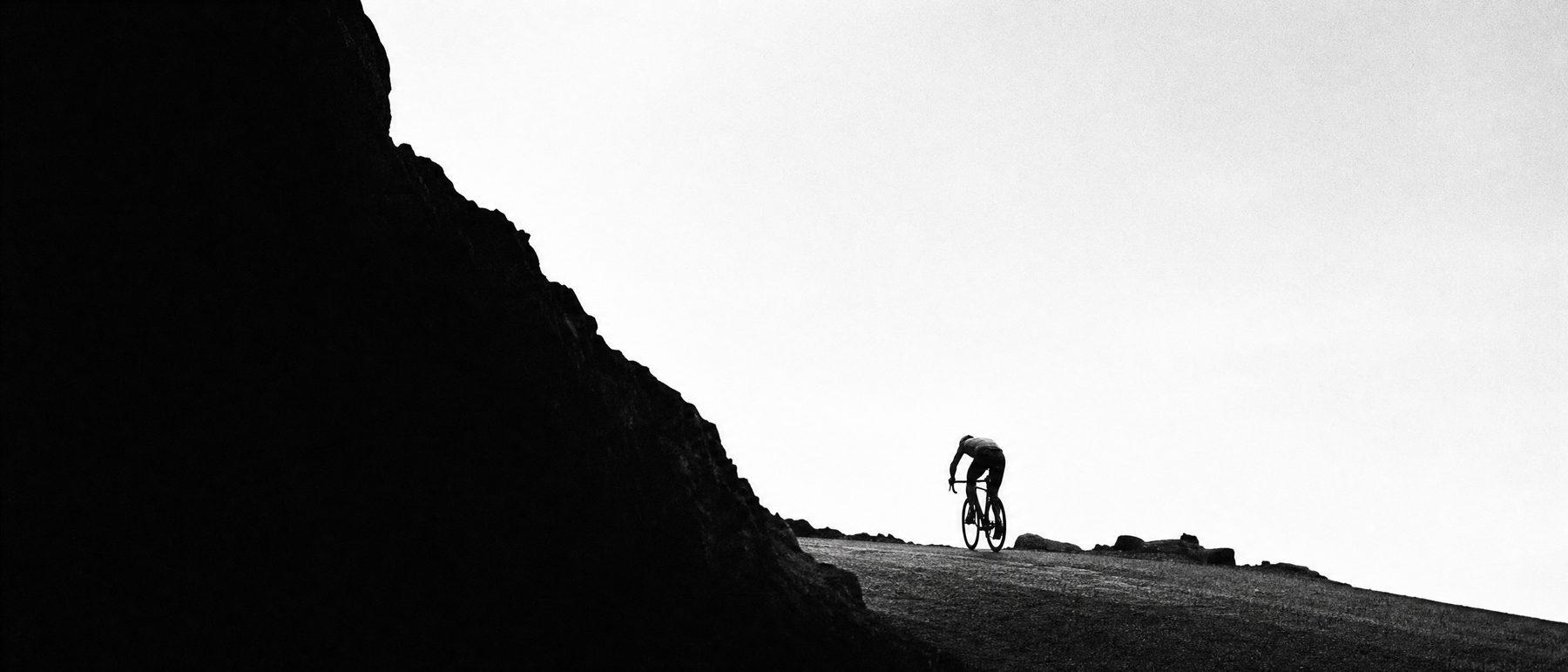 Bare rocky trail in midday heat, air shimmering.